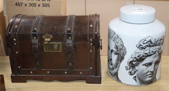 A Fornasetti style jar and cover and a small domed topped wooden chest (2)